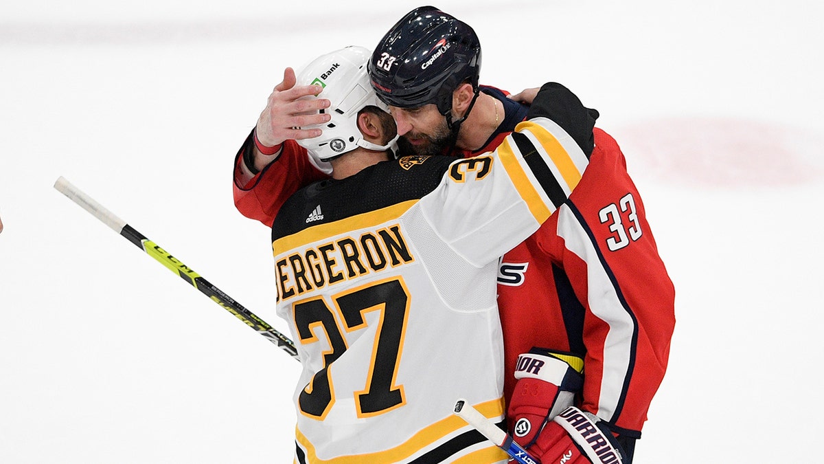 Patrice Bergeron and Zdeno Chara embrace