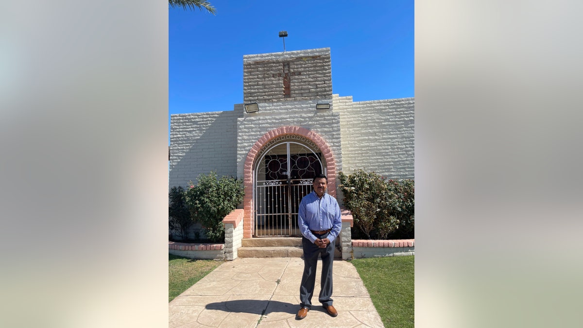 The Rev. Antonio Velazquez, an evangelical pastor originally from Guatemala, poses outside a Phoenix church on Thursday, May 17, 2021. (AP Photo/Anita Snow)