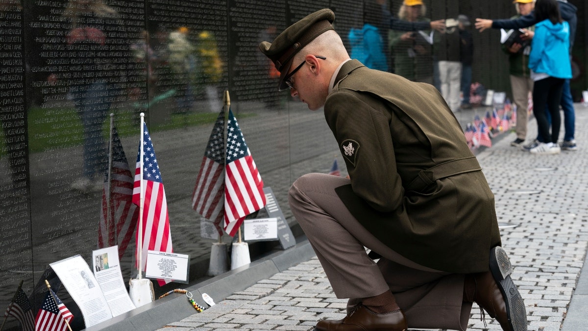 Army Spc. Joseph Wolfe reads the names of the fallen soldiers at Vietnam Veterans Memorial at the National Mall ahead of Memorial Day, in Washington, Sunday, May 30, 2021. (Associated Press)