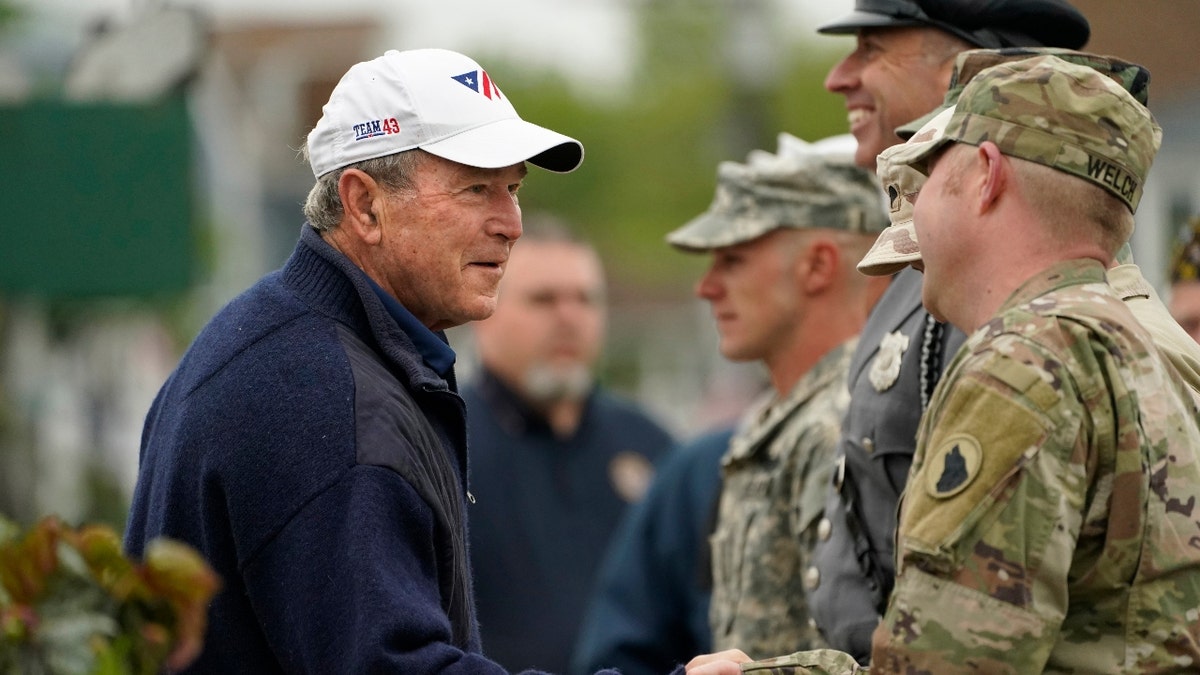 Former President George W. Bush thanks members of the American Legion Post 159 firing squad after a Memorial Day service in Kennebunkport, Maine, Monday, May 31, 2021. (AP Photo/Robert F. Bukaty)