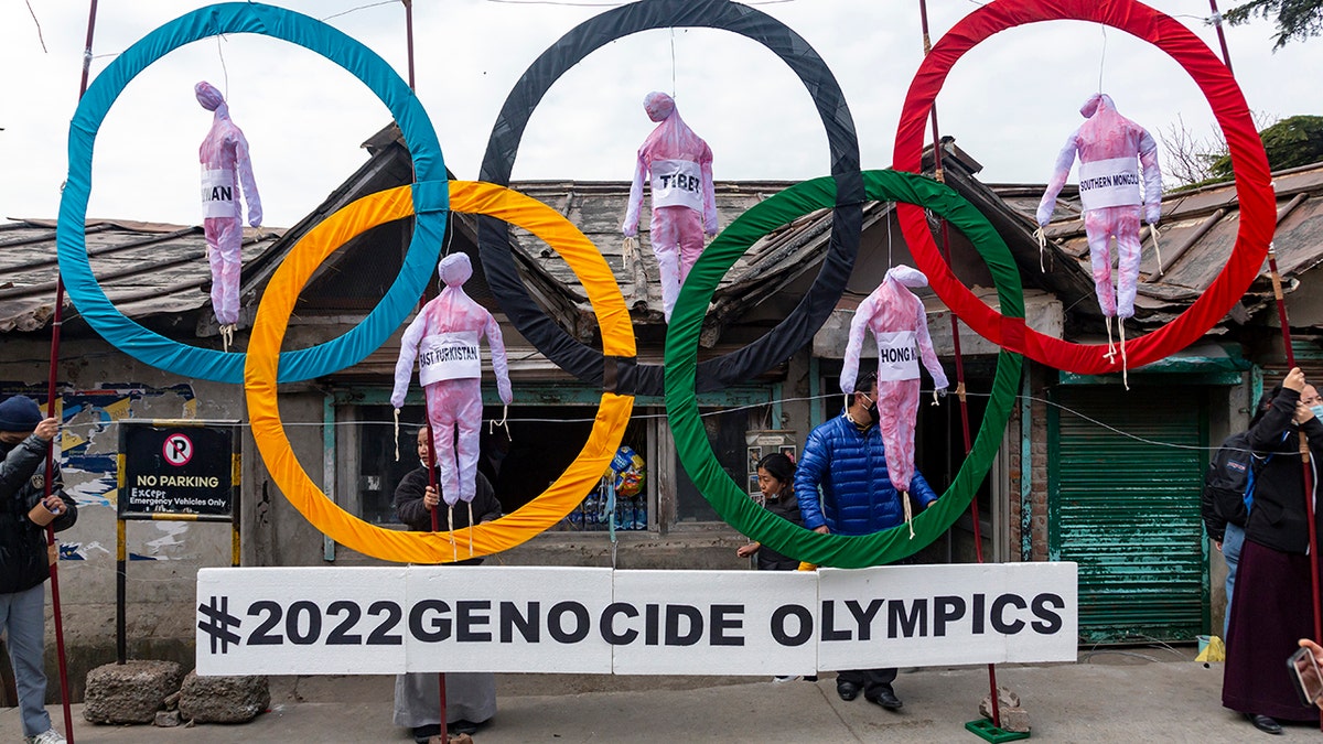 Tibetans use the Olympic Rings as a prop as they hold a street protest against the holding of the 2022 Beijing Winter Olympics, in Dharmsala, India.