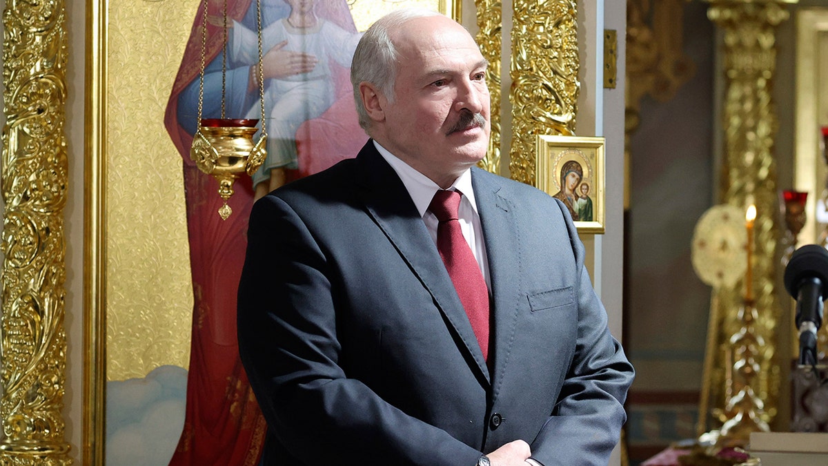 Belarusian President Alexander Lukashenko, left, attends the Orthodox Easter service in the town of Turov, some 270 km (167 miles) south of Minsk, Belarus, Sunday, May 2, 2021. (Maxim Guchek/BelTA Pool Photo via AP)