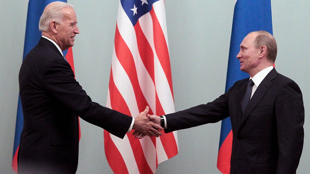 Russian Prime Minister Vladimir Putin (R) shakes hands with U.S. Vice President Joe Biden during their meeting in Moscow March 10, 2011. Biden is on the second day of an official visit meeting top officials in the Russian capital.  REUTERS/Alexander Natruskin (RUSSIA - Tags: POLITICS)