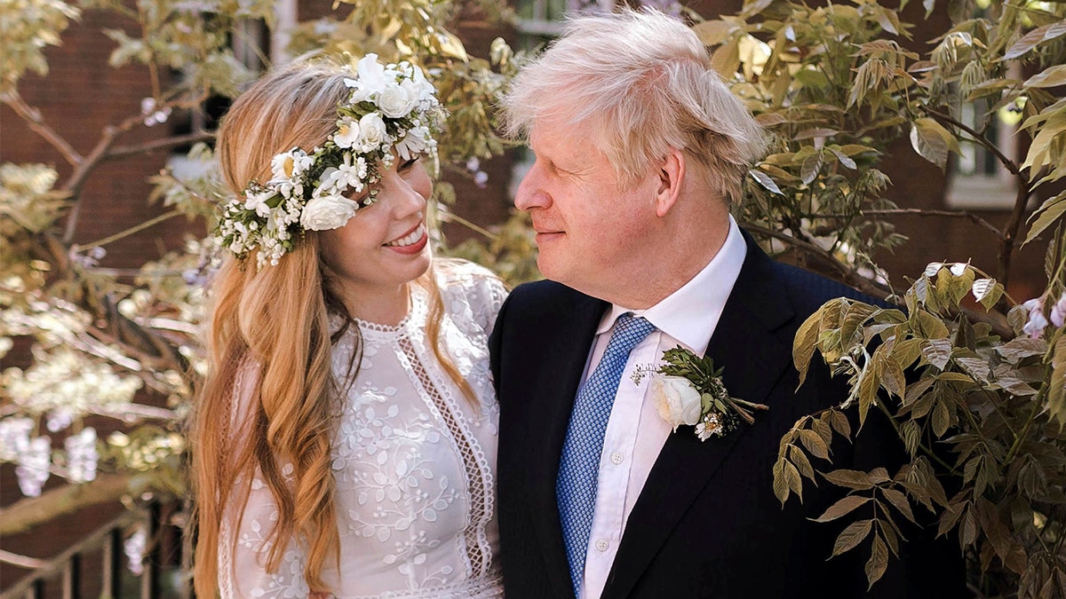 In this image released Sunday May 30, 2021, by Downing Street, Britain's Prime Minister Boris Johnson and Carrie Johnson pose together for a photo in the garden of 10 Downing Street after their wedding on Saturday. Boris Johnson and his fiancée Carrie Symonds are newlyweds, according to an announcement from his Downing Street office saying they were married Saturday May 29, in a small private ceremony in London. (Rebecca Fulton/Downing Street via AP)