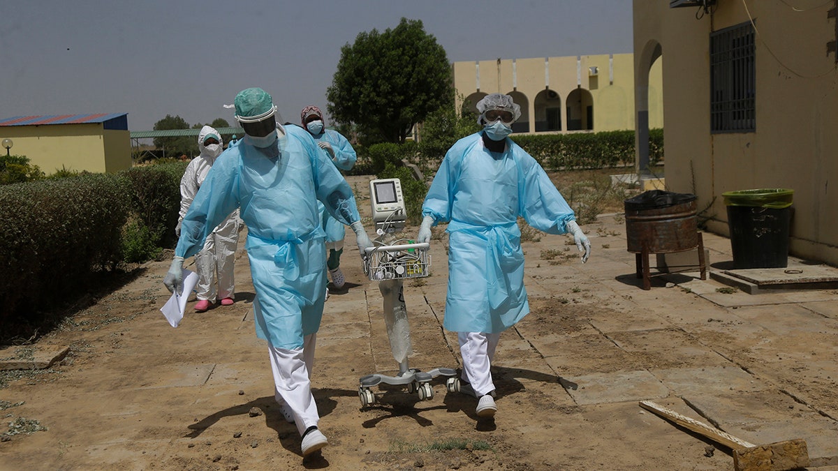 April 30, 2021: Doctors caring with COVID-19 patients ferry medical equipment, at the Farcha provincial hospital in N'Djamena, Chad.