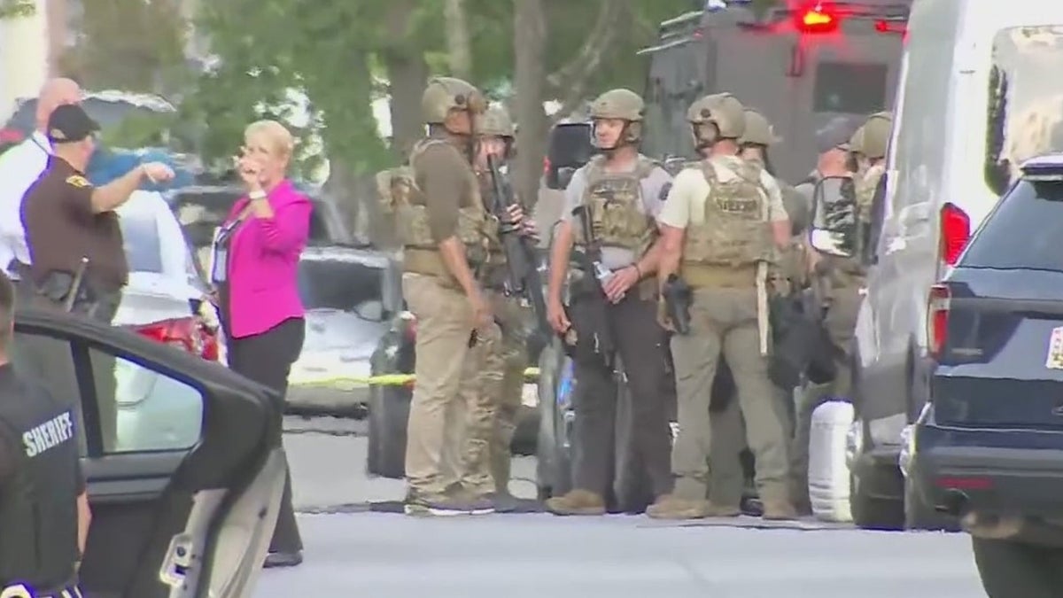 Authorities in Charles County, Md., gather amid a situation with a barricaded suspect who allegedly shot two officers Monday.  