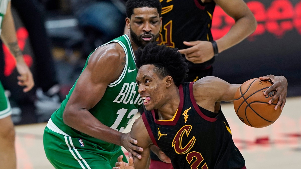 Cleveland Cavaliers' Collin Sexton (2) drives against Boston Celtics' Tristan Thompson (13) during the second half of an NBA basketball game Wednesday, May 12, 2021, in Cleveland. (AP Photo/Tony Dejak)