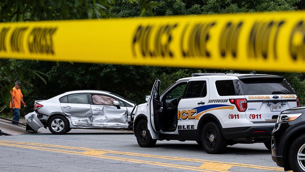 A wrecked car is removed from the scene where police fatally shot a man in downtown Decatur, Ga. on Tuesday morning, May 18, 2021. 