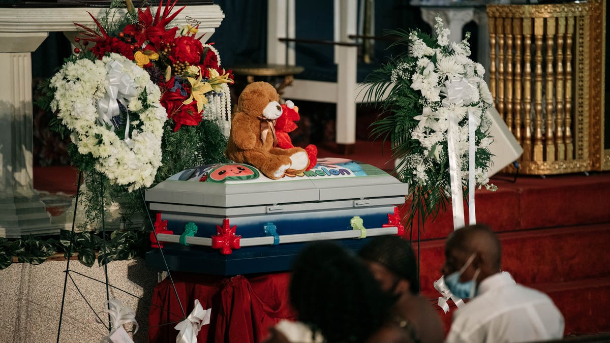 The casket of Davell Gardner Jr. sits near the altar of Pleasant Grove Baptist Church on July 27, 2020 in New York City. Family, local elected officials, and clergy gathered at Davell's funeral to mourn his loss and condemn the gun violence responsible for his death at a Brooklyn cookout on July 12. (Photo by Scott Heins/Getty Images)