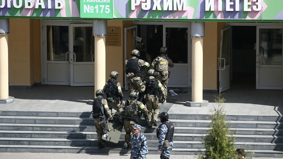 Officers by the Russian school where two attackers reportedly opened fire on May 11, 2021. (Photo by Yegor AleyevTASS via Getty Images)