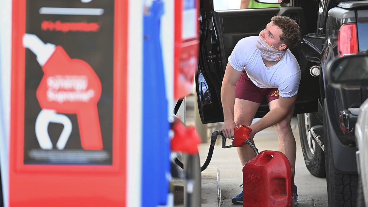A man fills up a gas container after filling up his vehicle at an Exxon gas station on Wednesday, May 12, 2021, in Springfield, Virginia.