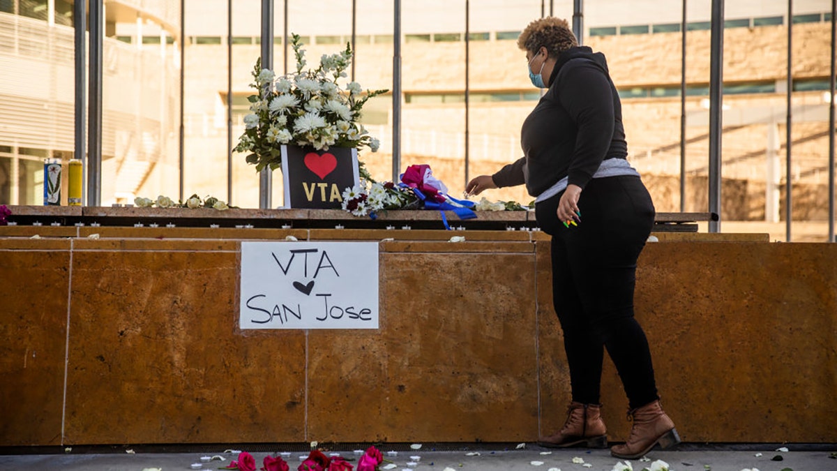 HERO Tent President Kiana Simmons places a candle at a vigil organized by her group following the mass shooting at the Valley Transportation Authority (VTA) light-rail yard, outside City Hall on May 26, 2021, in San Jose, California. (Getty Images)