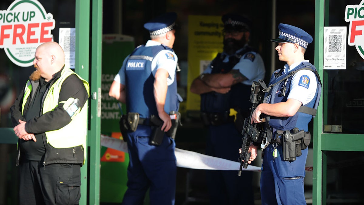 Police officers are observed standing guard outside the main entrance of the Dunedin Central Countdown on May 10, 2021, in Dunedin, New Zealand. (Photo by Joe Allison/Getty Images)