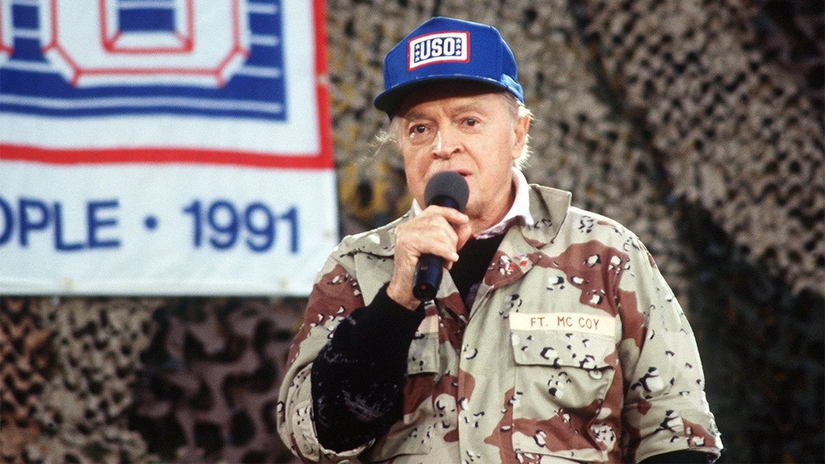 Entertainer Bob Hope performs for military personnel at the USO Christmas Tour, Operation Desert Shield during the Gulf War in 1990 in Saudi Arabia. 