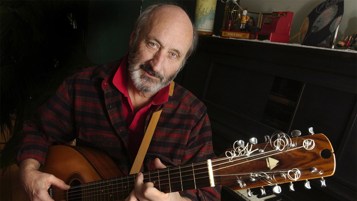 Noel Paul Stookey shows off a 12 string guitar custom-made by a Maine artisan, circa 2003. Stookey spends much of his time at his home in Blue Hill, Maine.