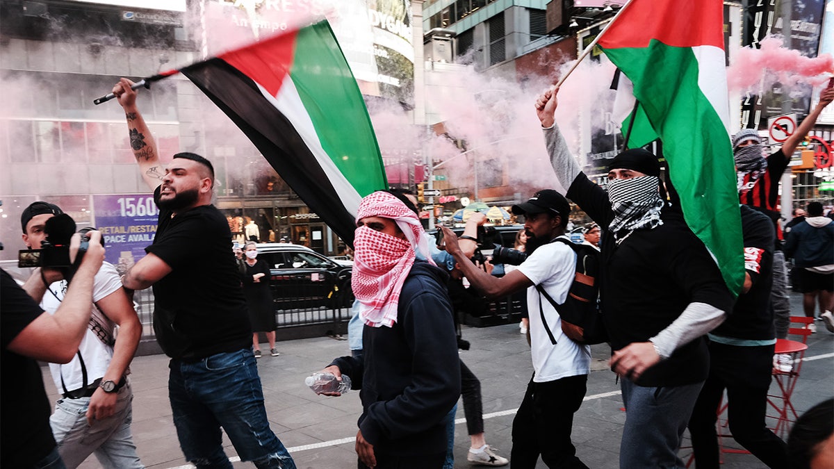 Pro-Palestinian protesters face off with a group of Israel supporters and police in a violent clash in Times Square on May 20, 2021 in New York City. 