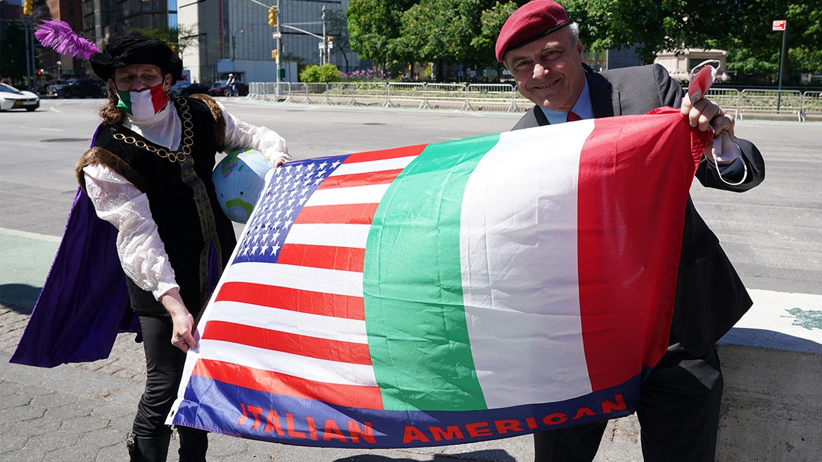 A man dressed as Christopher Columbus and mayoral candidate Curtis Sliwa hold a flag, as Italian American community groups hold a demonstration in Columbus Circle in New York on May 12, 2021 in support of Italian Heritage and Columbus Day. 