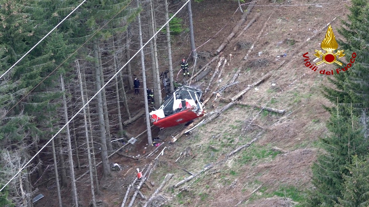 Rescuers work by the wreckage of the cable car. (AP/Vigili del Fuoco Firefighters)