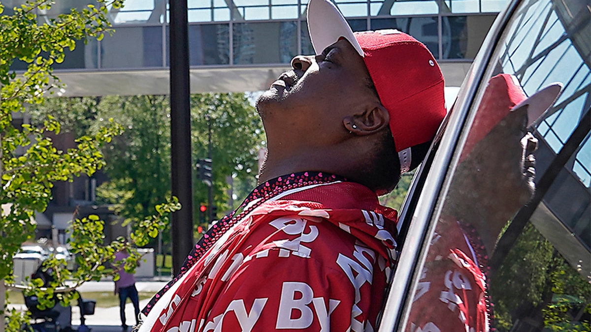 Anti-violence activist K.G. Wilson tips his head back in anguish while waiting to hear the status of his 6-year-old granddaughter who was shot in the head late Monday, Minneapolis, Tuesday, May 18, 2021. She later died. (David Joles/Star Tribune via AP)