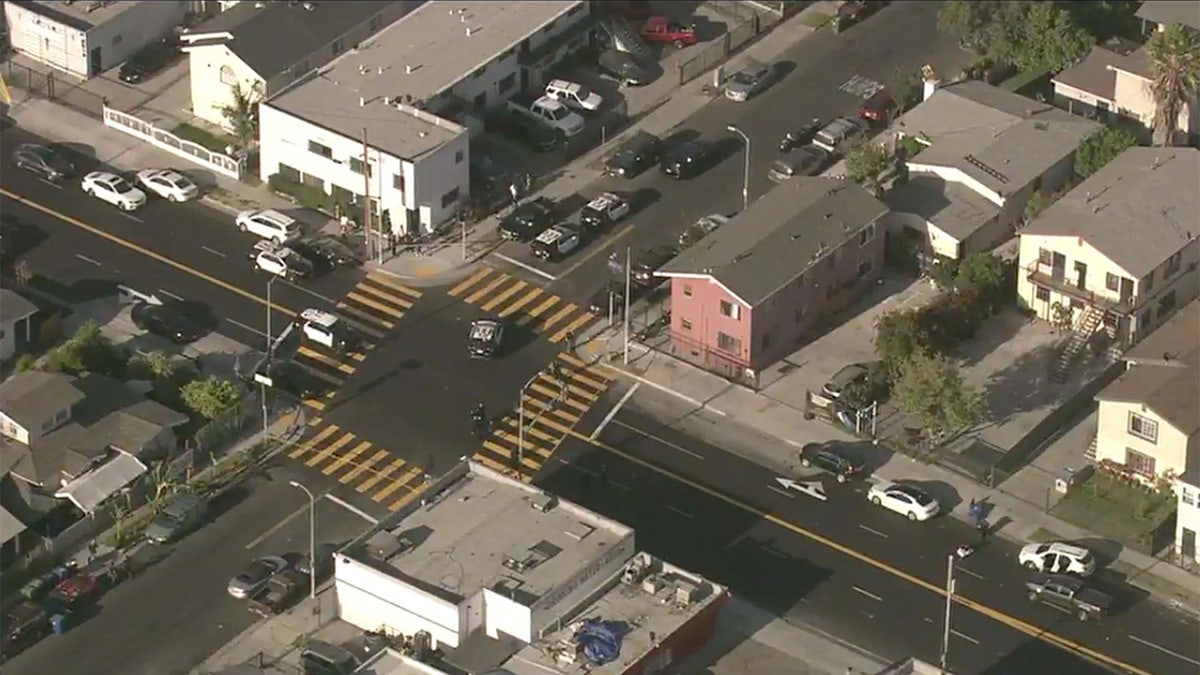 Aerial images above the scene show multiple police vehicles present at the San Francisco intersection where a double stabbing took place.