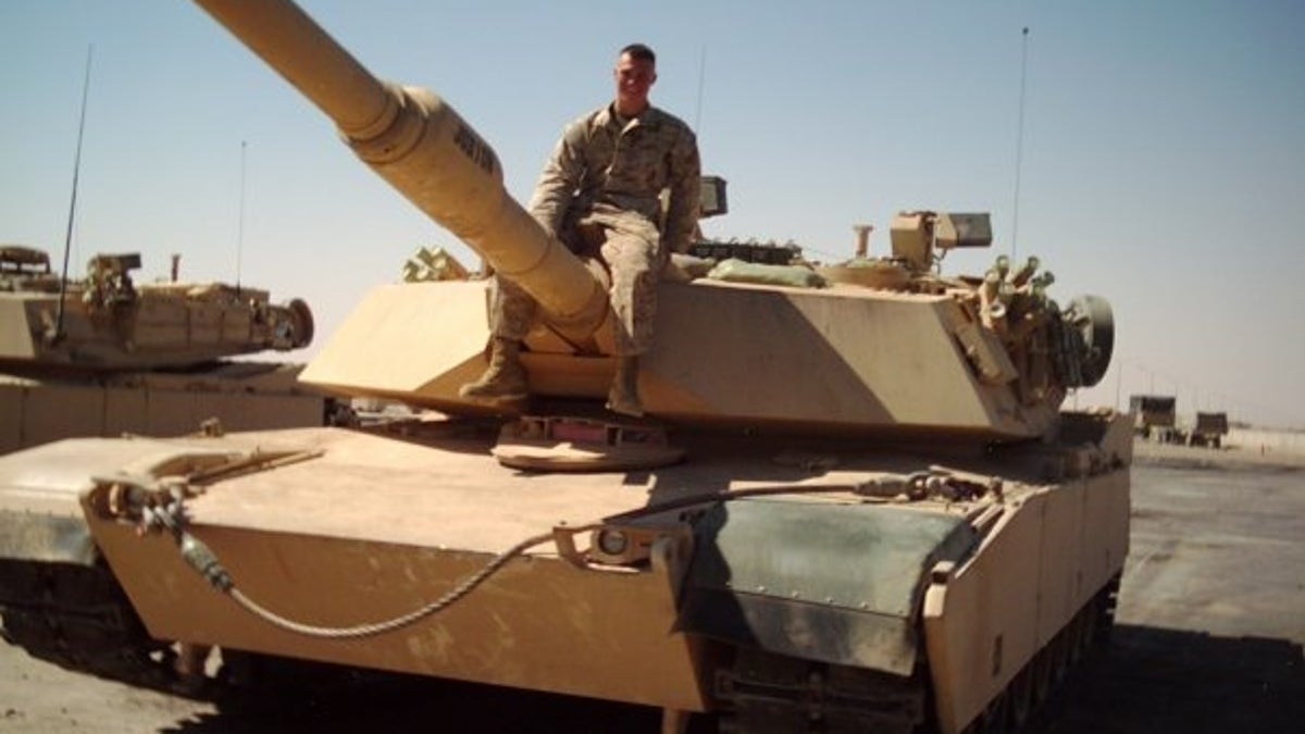 Private First Class Michael Logue on a tank