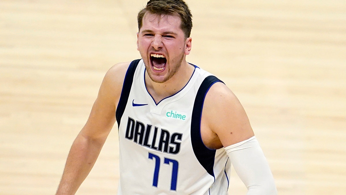 Dallas Mavericks guard Luka Doncic celebrates after a dunk by Kristaps Porzingis during the second half in Game 2 of the team's NBA basketball first-round playoff series against the Los Angeles Clippers on Tuesday, May 25, 2021, in Los Angeles.