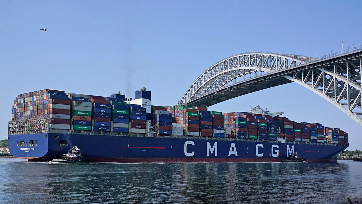 The CMA CGM Marco Polo passes underneath the Bayonne Bridge on its way to the Elizabeth-Port Authority Marine Terminal as seen from Bayonne, N.J., Thursday, May 20, 2021. (AP Photo/Seth Wenig)