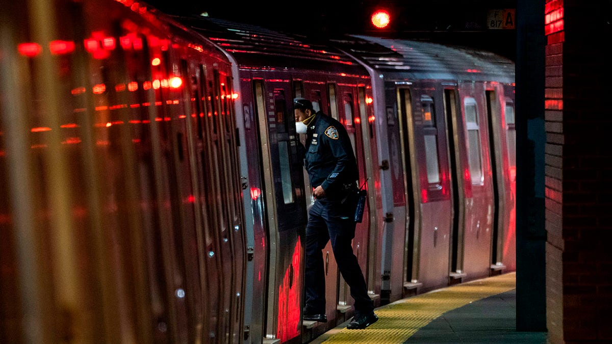 A Metopolitan Transportation Authority Police officer looks for passengers at the last stop at the Coney Island station in Brooklyn, New York.