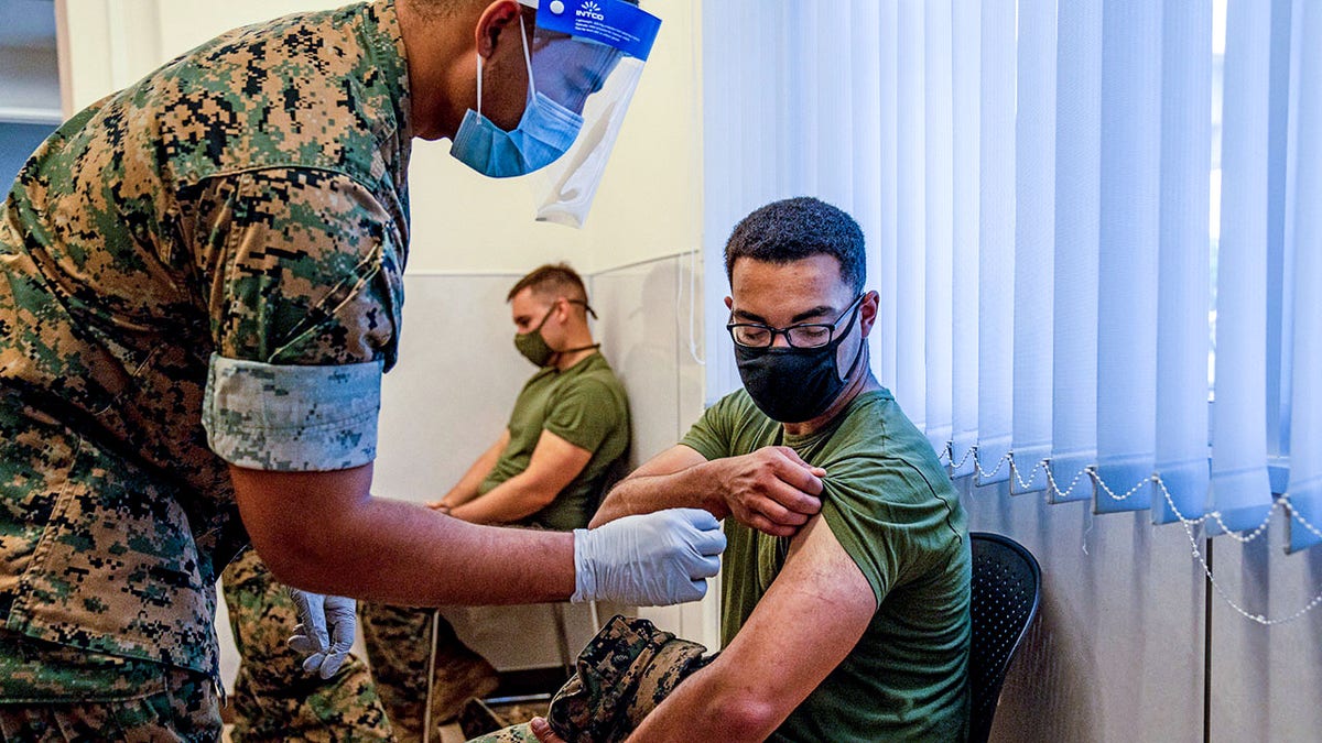 A United States Marine prepares to receive the Moderna coronavirus vaccine at Camp Hansen on April 28, 2021 in Kin, Japan.