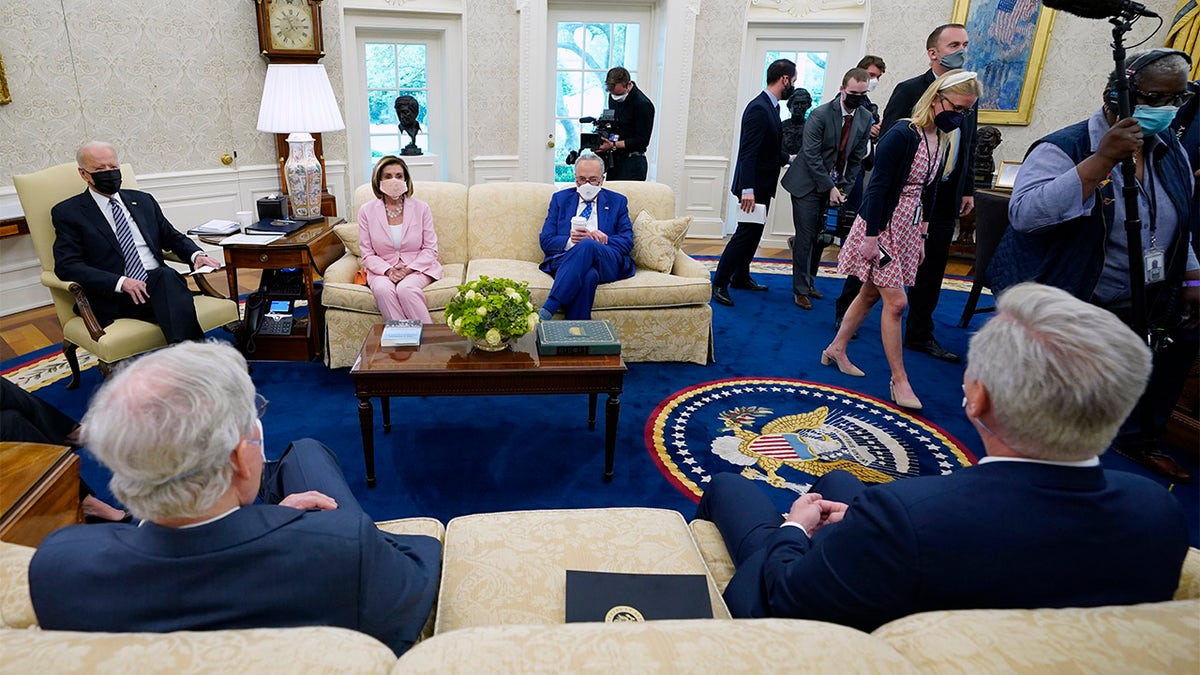 Members of the media are escorted out as President Joe Biden meets with congressional leaders in the Oval Office of the White House, Wednesday, May 12, 2021, in Washington. Clockwise from left, Biden, House Speaker Nancy Pelosi, Senate Majority Leader Chuck Schumer, Senate Minority Leader Mitch McConnell and House Minority Leader Kevin McCarthy. 