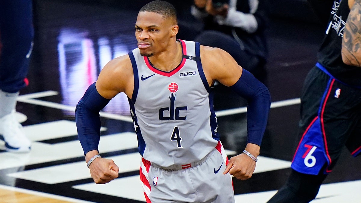 Washington Wizards' Russell Westbrook, left, reacts past Philadelphia 76ers' Danny Green after a dunk during the first half of Game 2 in a first-round NBA basketball playoff series, Wednesday, May 26, 2021, in Philadelphia. (AP Photo/Matt Slocum)