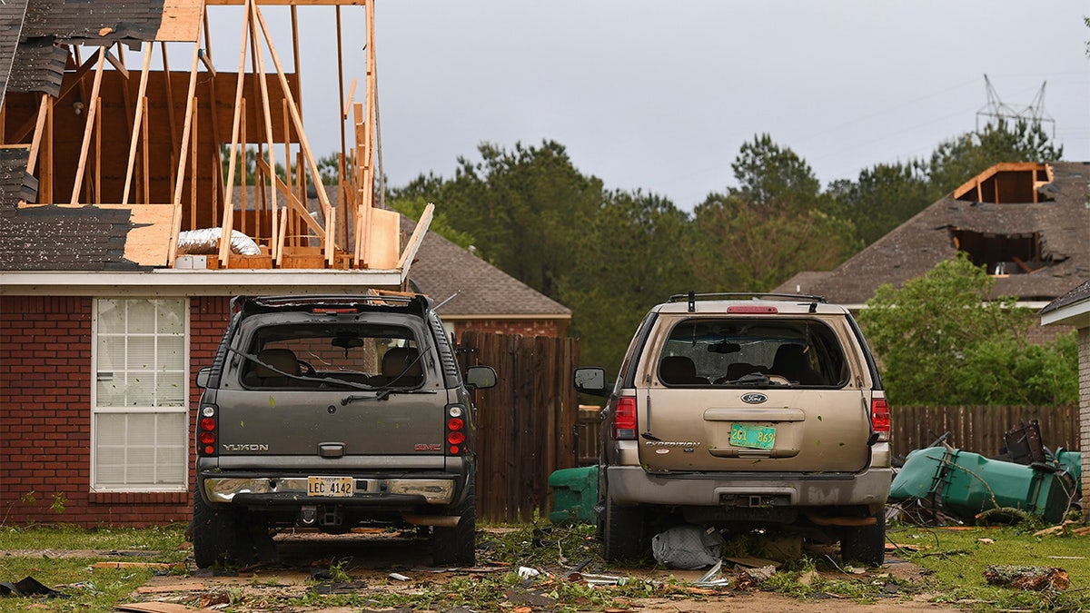 Damaged homes and vehicles are seen along Elvis Presley Drive in Tupelo, Miss., Monday, May 3, 2021. (AP Photo/Thomas Graning)