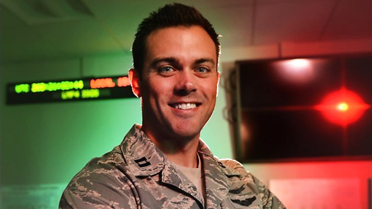 Lt Col. Matthew Lohmeier, 460th Operations Group Block 10 chief of training, stands in the Standardized Space Trainer July 22, 2015, on Buckley Air Force Base, Colo.