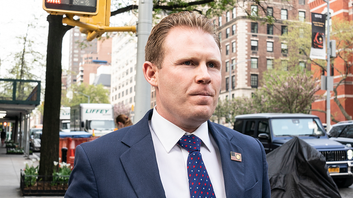 Andrew Giuliani walks the street after leaving her father Rudy Giuliani's apartment in 2021.