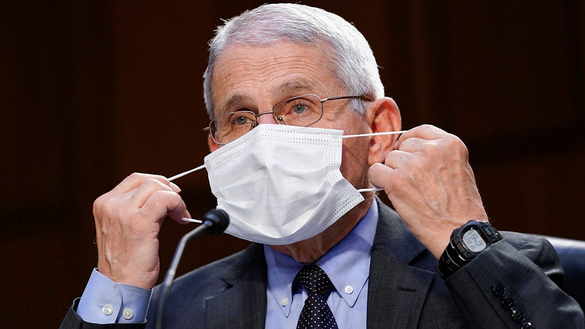 Dr. Anthony Fauci, director of the National Institute of Allergy and Infectious Diseases, adjusts a face mask during a Senate Health, Education, Labor and Pensions Committee hearing on the federal coronavirus response on Capitol Hill on March 18, 2021 in Washington, DC. (Photo by Susan Walsh-Pool/Getty Images)