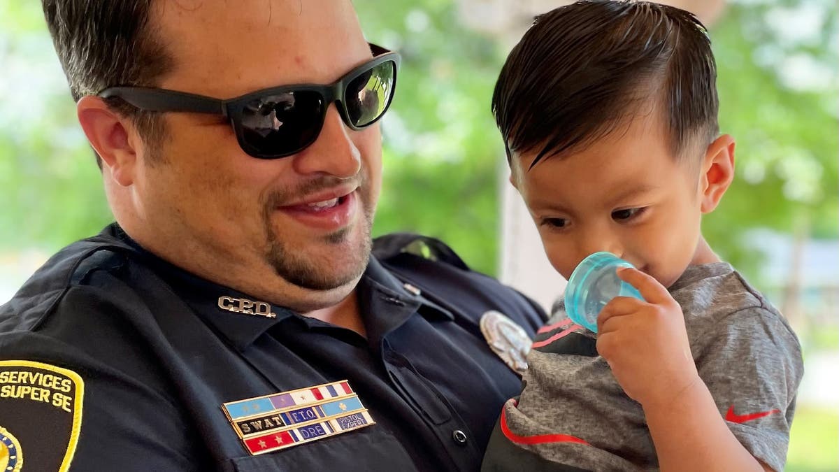 Covington PD officer Matt Holbrook saved 15-month-old Adrian Tovar by giving him back thrusts that dislodged the child's obstructed airway. 