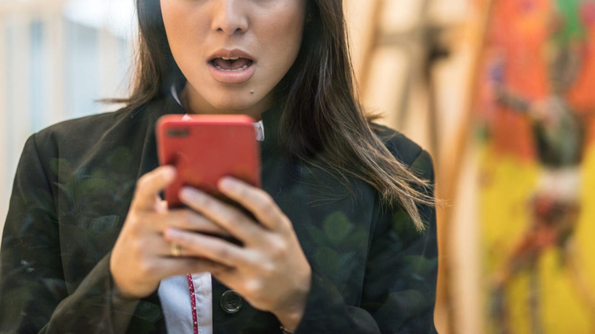 Woman worried about the news on her mobile phone
