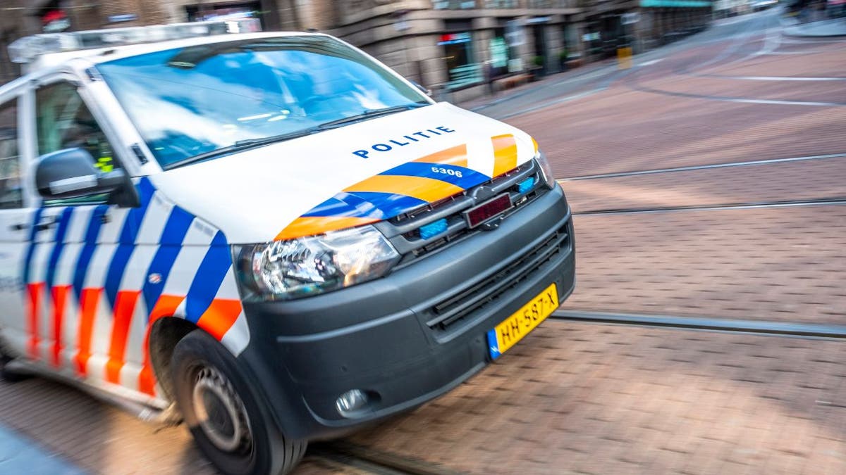 Dutch police car rushing to the scene of an incident in Amsterdam.