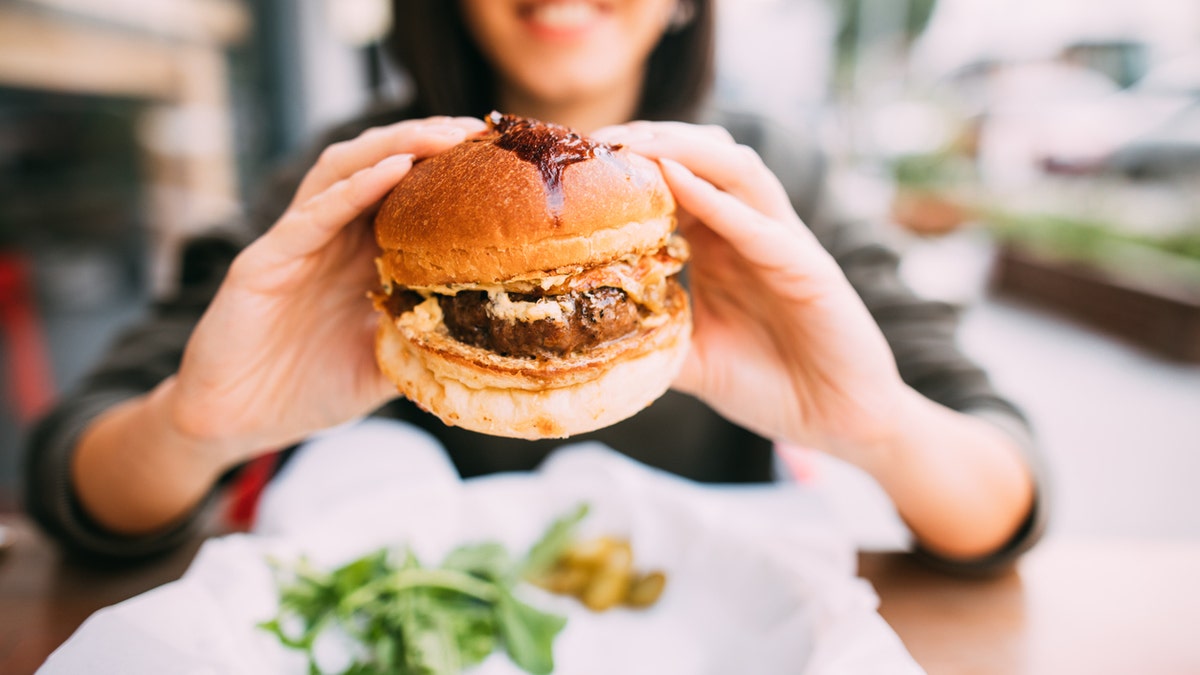 Woman eating beef burger