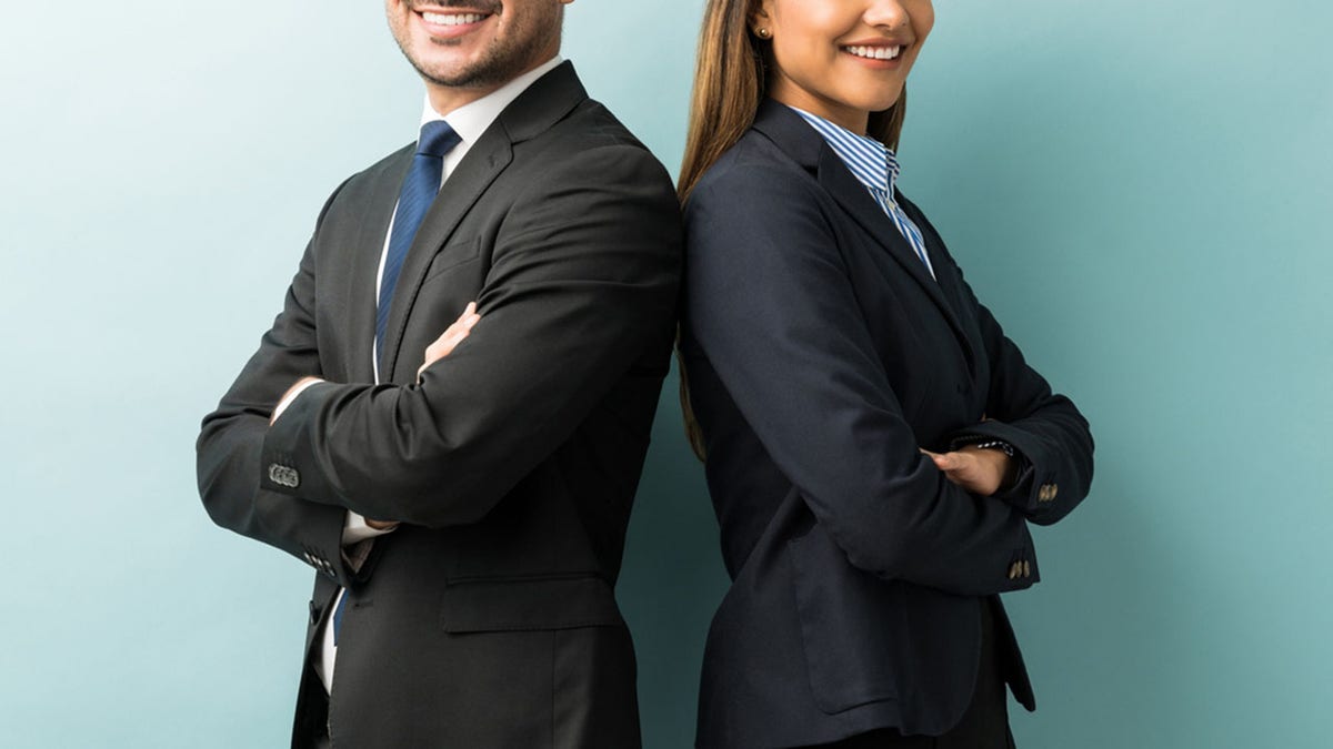 Business Colleagues Standing With Arms Crossed In Studio