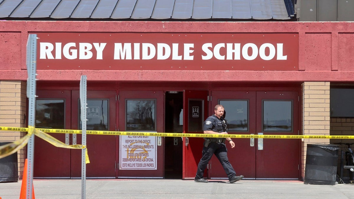 A police officer walks out of Rigby Middle School following a shooting there on Thursday. (AP)