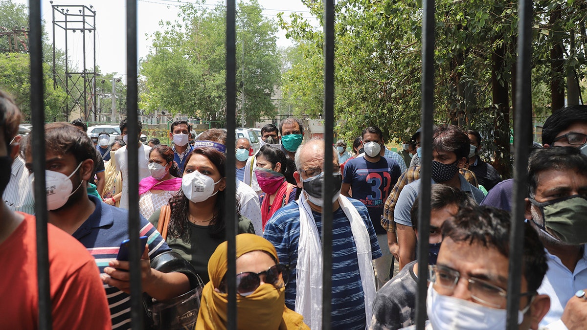 May 10, 2021: In this file photo, people waiting to get vaccinated against the coronavirus stand outside the closed gates of a hospital in Ghaziabad, outskirts of New Delhi, India.