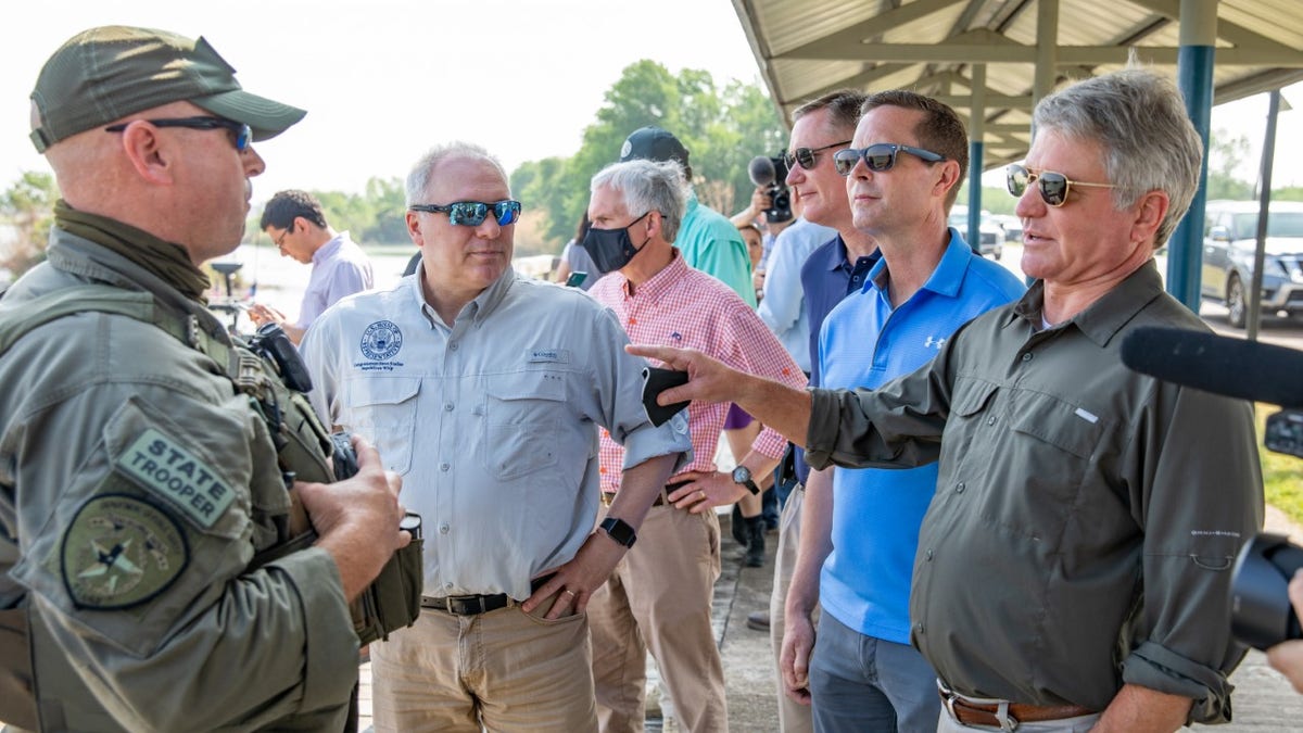 Rep. Michael McCaul (right) speaks to Border Patrol agents at the Rio Grande Valley in Texas.