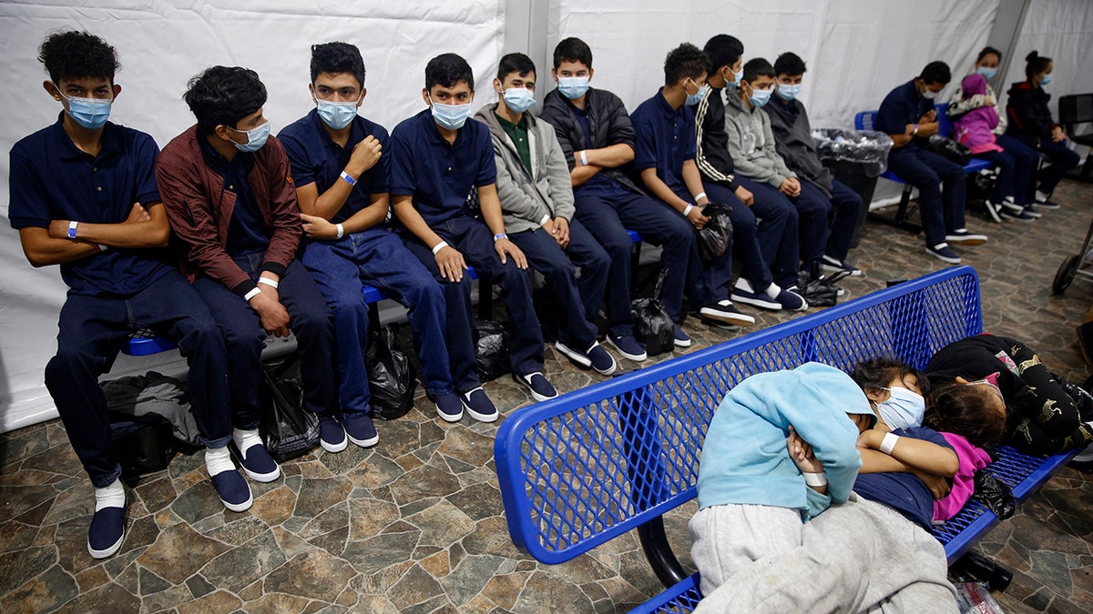 In this March 30, 2021, file photo, young unaccompanied migrants wait for their turn at the secondary processing station inside the U.S. Customs and Border Protection facility, the main detention center for unaccompanied children in the Rio Grande Valley, in Donna, Texas. The number of unaccompanied children encountered on the U.S. border with Mexico in April 2021 eased from an all-time high a month earlier, while more adults are coming without families. Authorities encountered nearly 17,200 children traveling alone, down 9% from March but still far above the previous high in May 2019. (AP Photo/Dario Lopez-Mills, Pool, File)