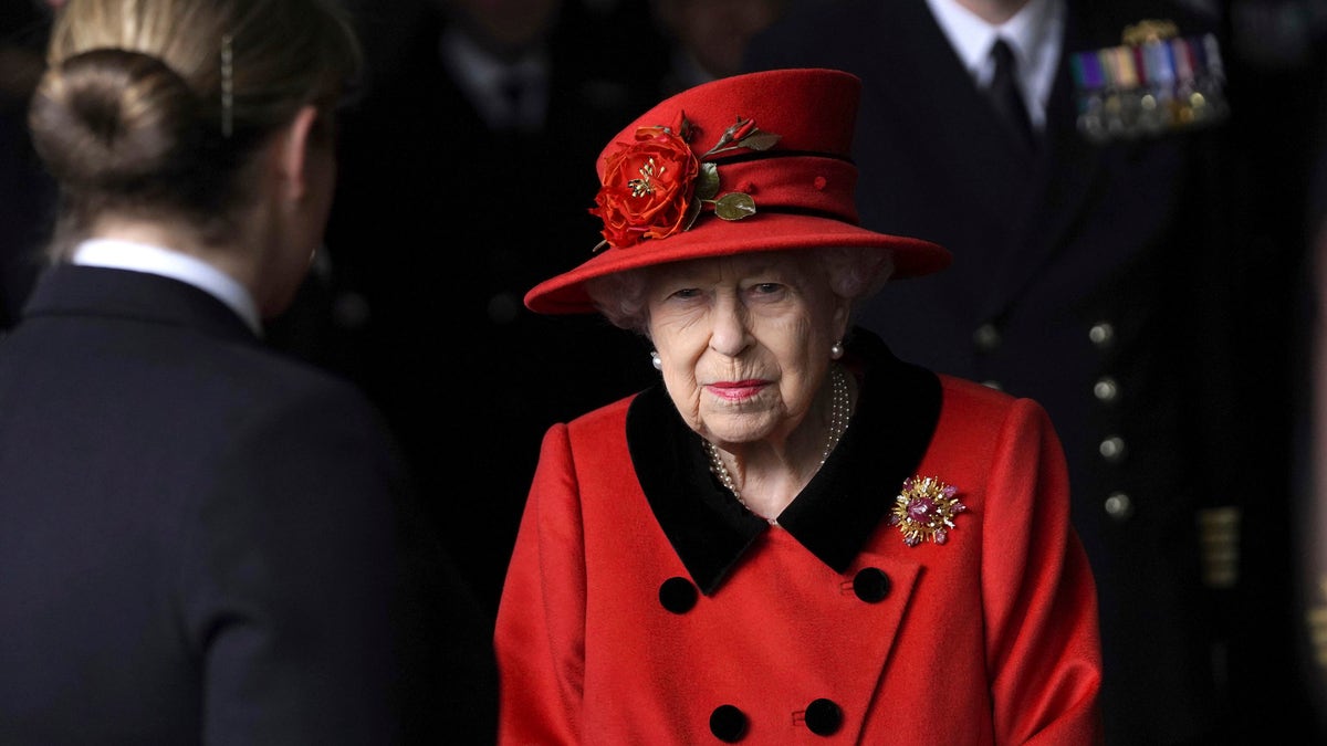 Britain's Queen Elizabeth II smiles during a visit to HMS Queen Elizabeth at HM Naval Base, ahead of the ship's maiden deployment, in Portsmouth, England, Saturday May 22, 2021. The monarch wore a brooch reportedly given to her by the late Prince Philip for the outing. (Steve Parsons/Pool Photo via AP)