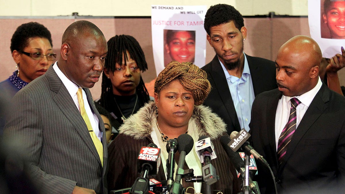 Samaria Rice (C), the mother of Tamir Rice, the 12-year old boy who was fatally shot by police last month while carrying what turned out to be a replica toy gun, speaks surrounded by Benjamin Crump (L), Leonard Warner (2nd R) and Walter Madison (R) during a news conference at the Olivet Baptist Church in Cleveland, Ohio December 8, 2014. The mother of a 12-year-old Cleveland boy fatally shot by police last month broke her silence on Monday, saying the officers involved should be criminally convicted.  REUTERS/Aaron Josefczyk  (UNITED STATES - Tags: CRIME LAW CIVIL UNREST)