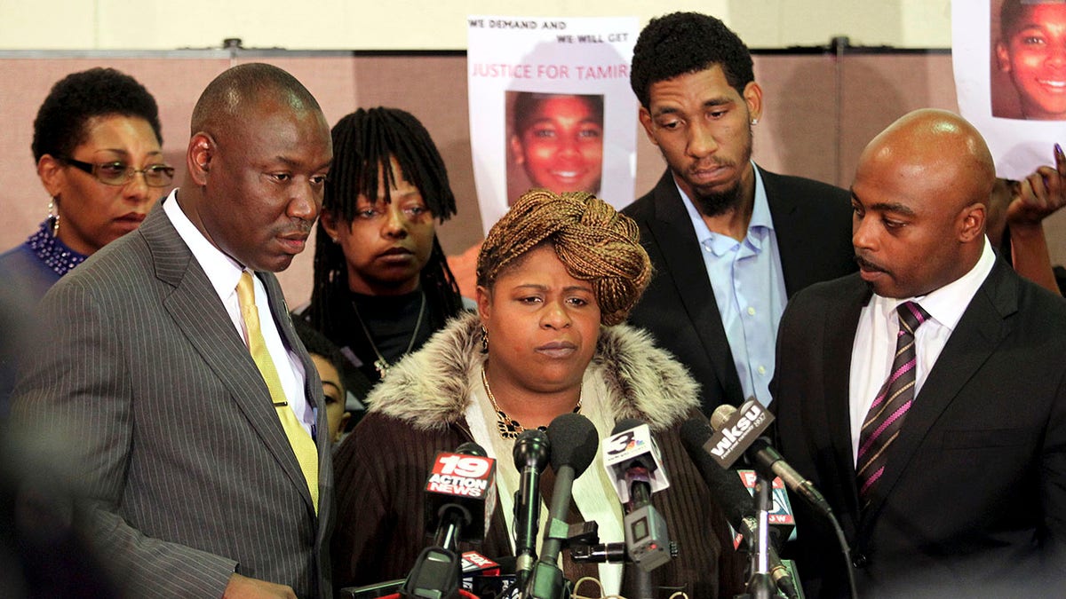 Samaria Rice (C), the mother of Tamir Rice, the 12-year old boy who was fatally shot by police last month while carrying what turned out to be a replica toy gun, speaks surrounded by Benjamin Crump (L), Leonard Warner (2nd R) and Walter Madison (R) during a news conference at the Olivet Baptist Church in Cleveland, Ohio December 8, 2014. The mother of a 12-year-old Cleveland boy fatally shot by police last month broke her silence on Monday, saying the officers involved should be criminally convicted. ?REUTERS/Aaron Josefczyk ?(UNITED STATES - Tags: CRIME LAW CIVIL UNREST)