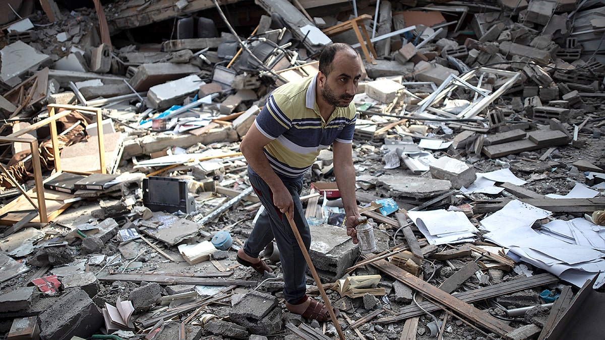 A Palestinian man inspects the damage of a house destroyed by an early morning Israeli airstrike, in Gaza City, Tuesday, May 18, 2021. (Associated Press)