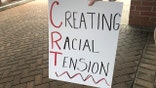 A protester holds a sign outside a building as the Noblesville school board meets inside on Tuesday, May 4, 2021. The protesters, who wouldn't provide their names, said they didn't want the schools to teach critical race theory, a concept that examines systemic racism as a part of American life. The district said it doesn't teach critical race theory.Noblesville Sign