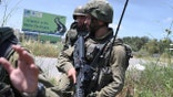 Israeli soldiers hold positions at Netiv Ha'Asara near the site where an IDF vehicle was directly hit by a rocket fired from Gaza strip, injuring 2 and killing one, in Netiv Ha'Asara. May 12, 2021.  (Photo by Gili Yaari/NurPhoto via Getty Images)